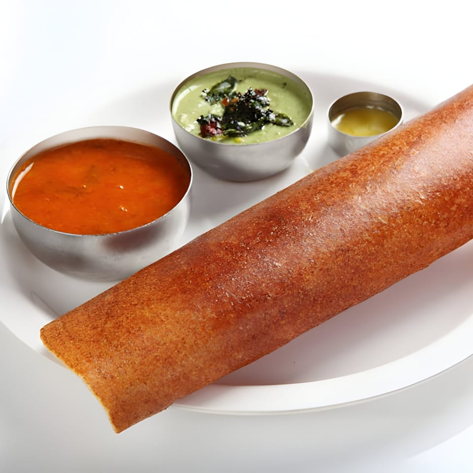 Annapurna Eats' dosa, a crispy Indian crepe, with sambar, coconut chutney, and ghee.