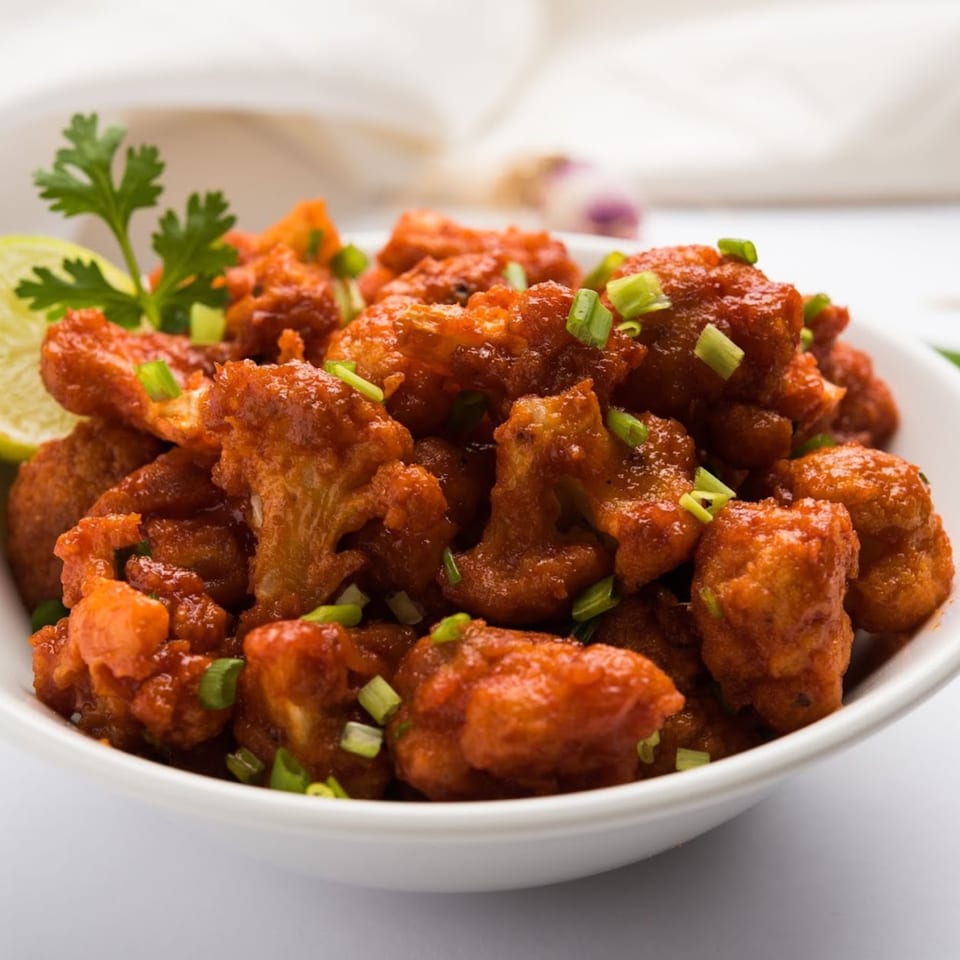 Annapurna Eats' Gobi Manchurian, a vibrant Indian appetizer with crispy cauliflower, scallions, and lime.